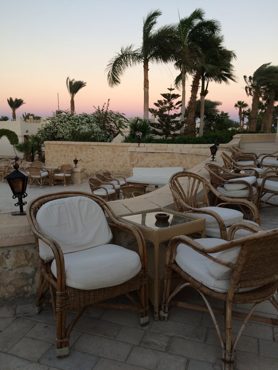 brown outdoor wicker tables and armchairs