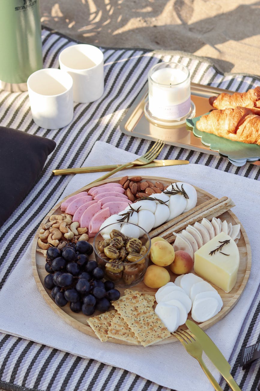 charcuterie board on a towel on a beach